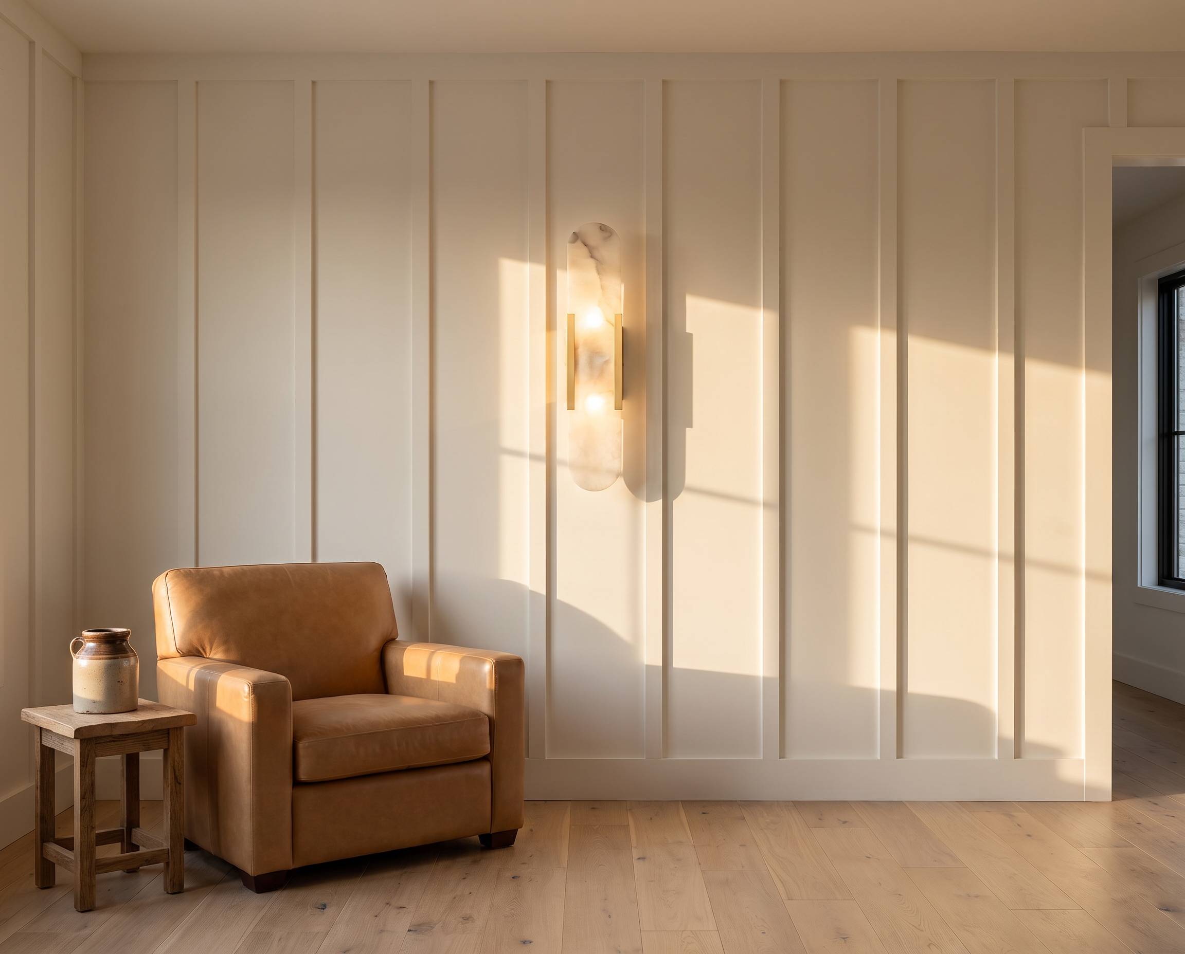 Alabaster wall sconce on a panelled wall