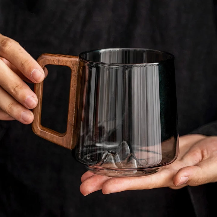 Elegant slanted coffee cups made of smoky glass with walnut wood handle